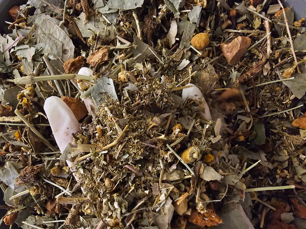 Organic herbal mix for detox tea, featuring a blend of dried leaves and flowers for full body cleansing.
