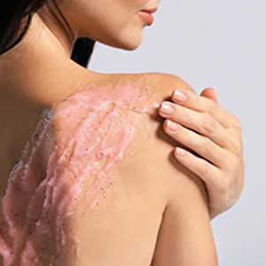 Fleurissent Rose Body Scrub applied on shoulder, promoting exfoliation and hydration for glowing skin.