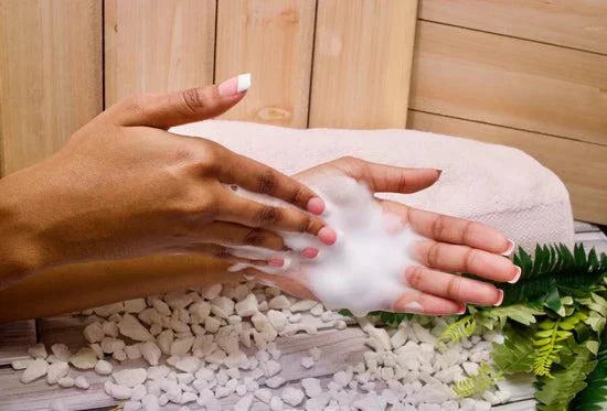 Daily Feminine Foaming Wash being applied to hands with foamy lather.