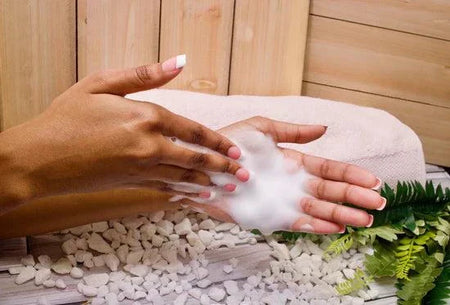 Daily Feminine Foaming Wash being applied to hands with foamy lather.