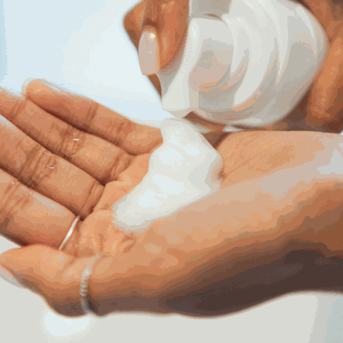 Anu Youthful Daily Facial Cleansing Foam being dispensed into hands.
