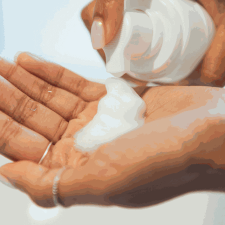 Anu Youthful Daily Facial Cleansing Foam being dispensed into hands.