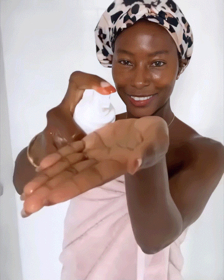 Daily Feminine Foaming Wash being dispensed by a woman wrapped in a towel, emphasizing gentle care and pH balance for sensitive skin.