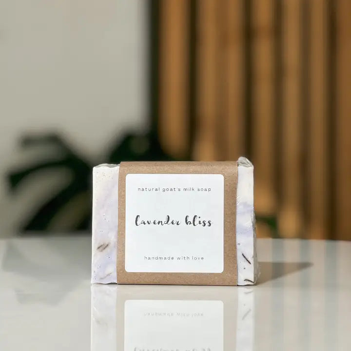 Bar of soap with a label on a reflective surface, blurred background