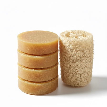 Stack of soap bars and a loofah