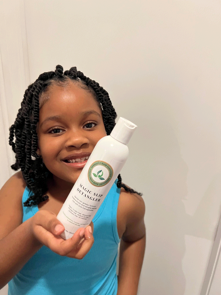 Child holding Magic Slip Detangler bottle for gentle hair detangling and softness